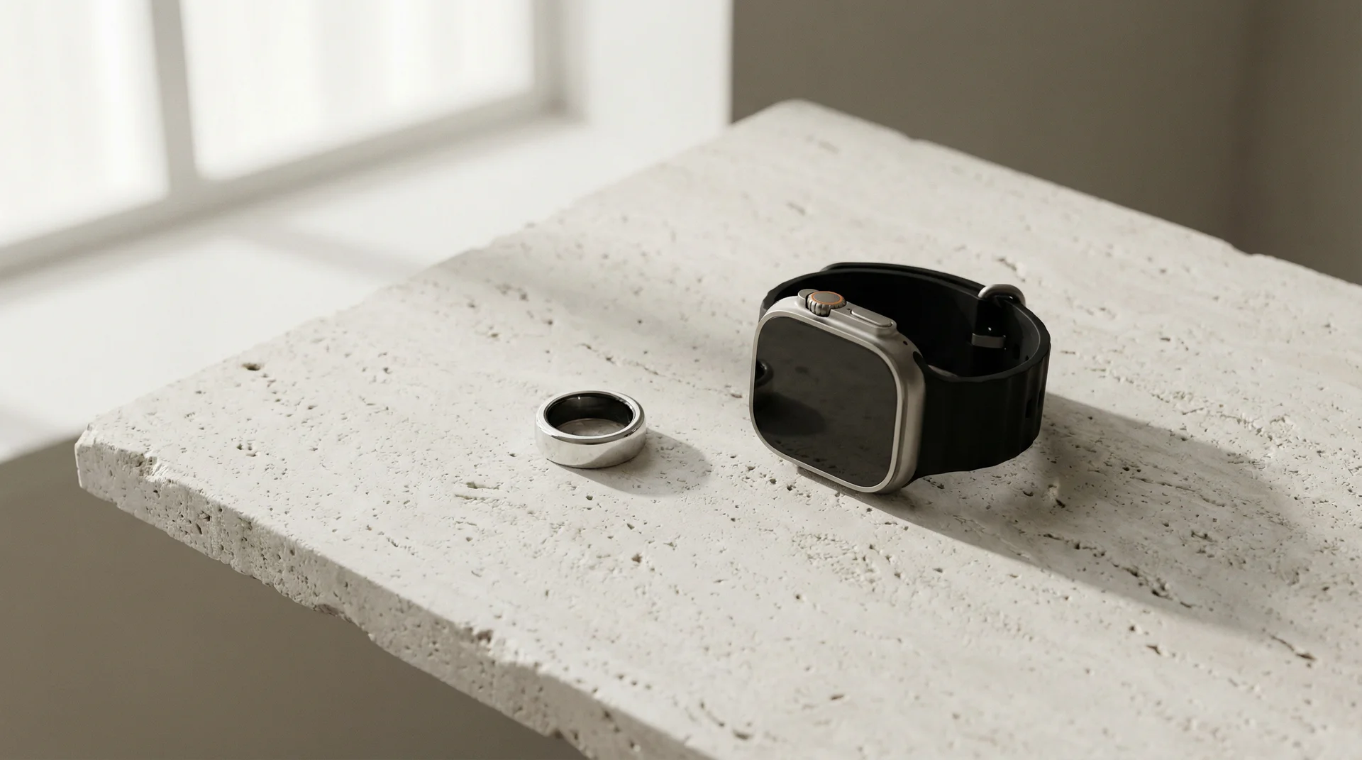 Oura Ring and Apple Watch on stone surface